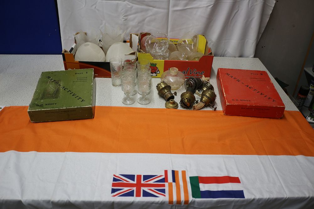 Lot 323: A Vintage South African Flag, Textbooks, Glassware, and Lamp Parts