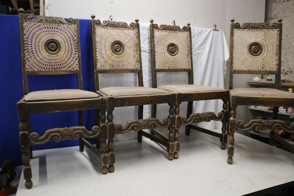 Lot 350: A Set of Four French Oak Breton Styled Carved Wood and Cane Back Chairs