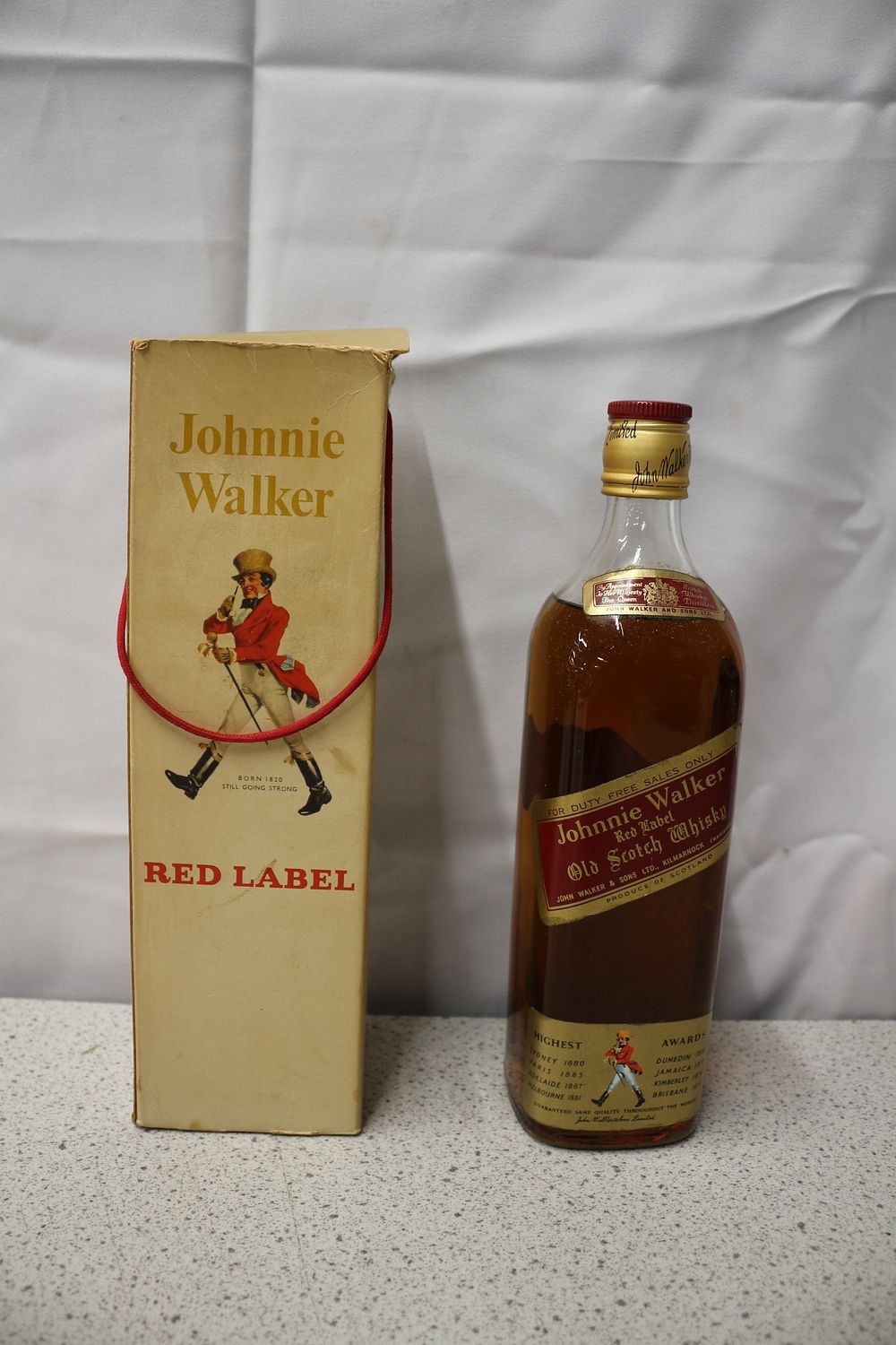 Lot 334: A 1960'a/70's Johnnie Walker Red Label Old Scotch Whisky Bottle and Original Box