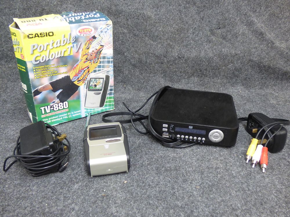 Lot 176: Two Electronic Items Including Casio TV-880 and EVO Labs Player