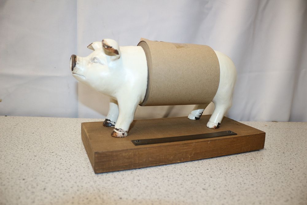 Lot 283: Off-White Cast Iron Pig-Shaped Paper Towel Holder on Wooden Base