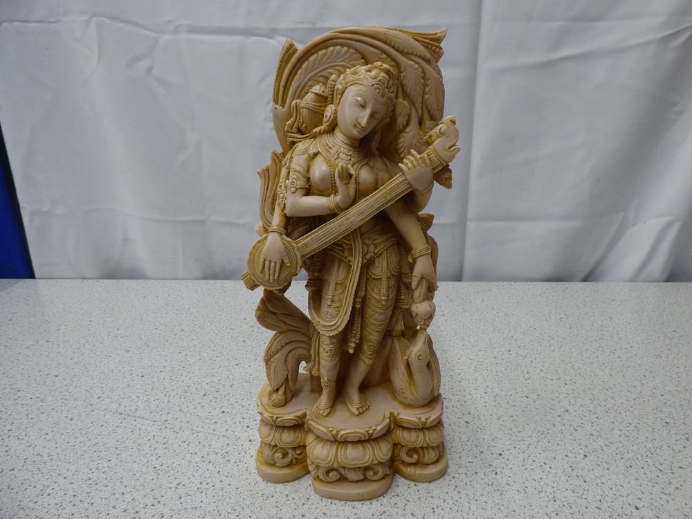 Lot 269: A Creamy Beige Saraswati Goddess Statue Playing Veena