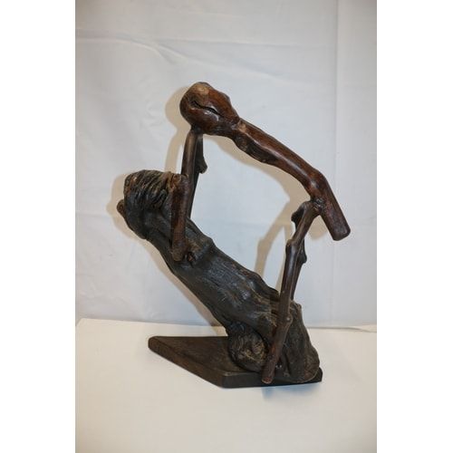 Lot 412: A Dark Brown Abstract Wooden Sculpture
