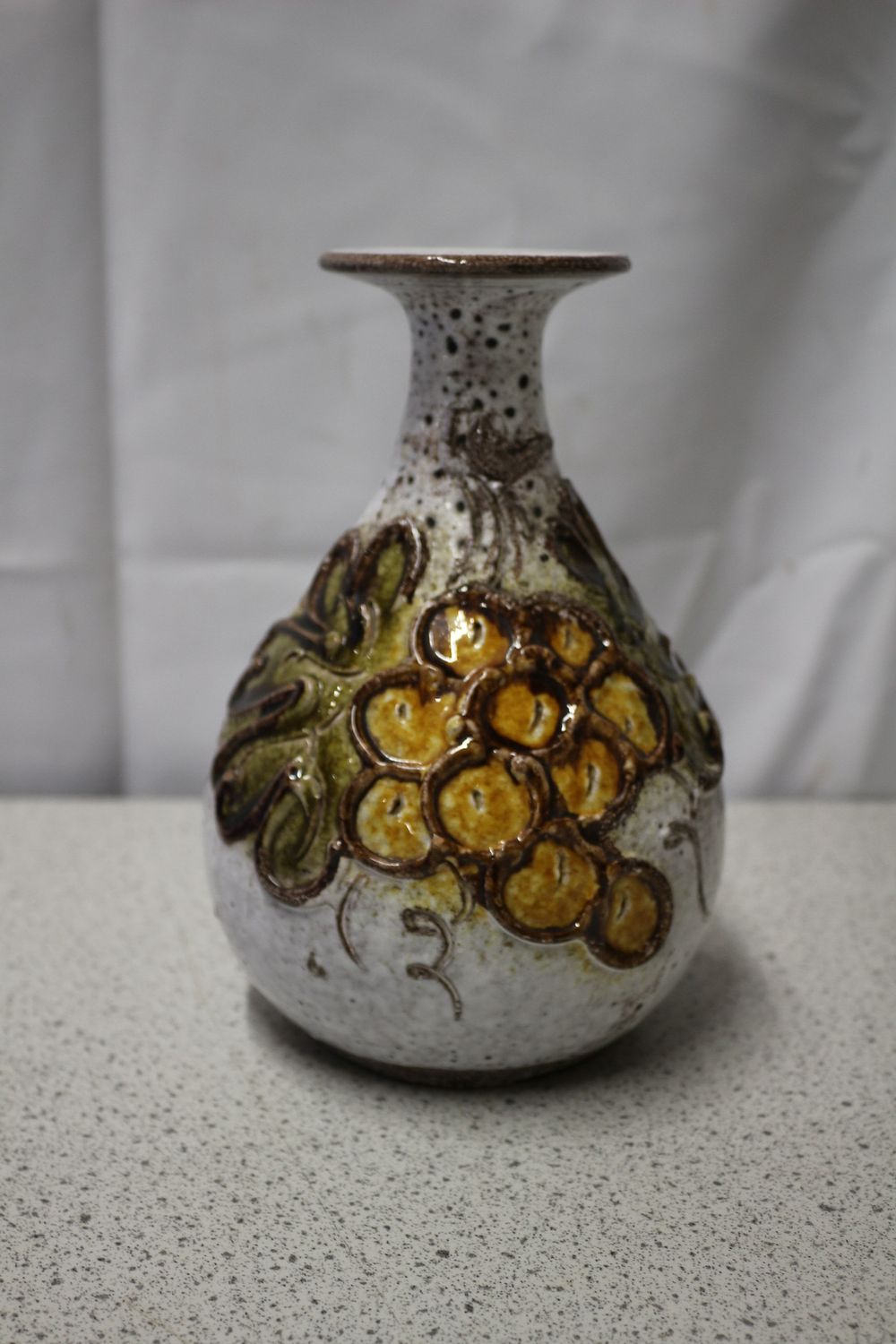 Lot 238: A Ceramic Fat Lava Vase with Grape and Leaf Decoration from The Noble Excellence Maritage Collection