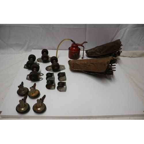 Lot 324: A Mixed Lot of an Oil Can, Saddles, and Casters and Skateboard Wheels