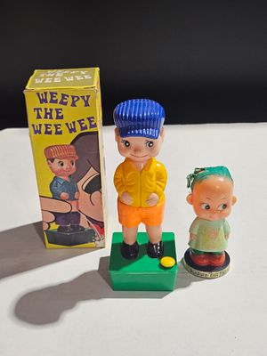 Two Vintage Plastic Novelty Figurines Including Boxed Weepy the Wee Wee. This lot features two 