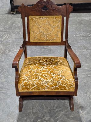 American late Victorian carved walnut platform rocking chair. This American late Victorian 