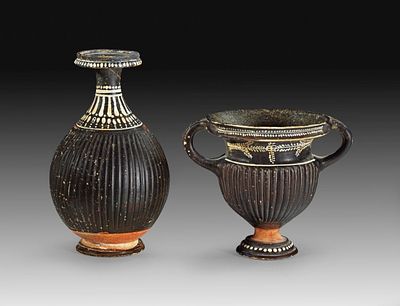Two Apulian vases of the Gnathia Ware. 2nd half 4th century BC. Black glaze ware with ribbed 