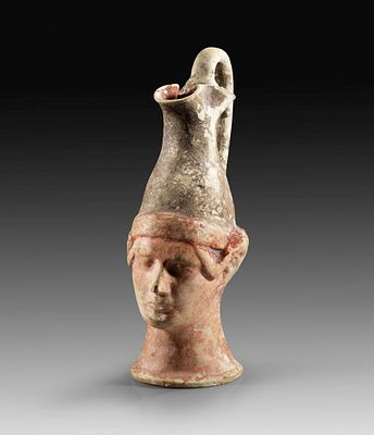 Figural Apulian oinochoe. Canosa, 3rd century BC. Height with handle 17,6cm. Jug with treefoil 