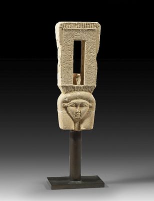 A finely carved limestone sistrum. A finely carved limestone sistrum with the head of the 