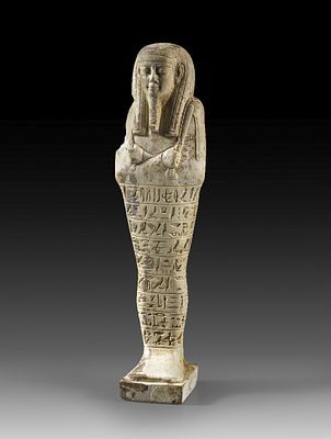 Ushabti of Teos. Ushabti of Teos, son of Tairit. White shimmering faience, H 19cm. Mummy-shaped 