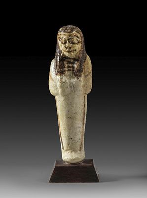 Ushabti of glazed faience. Ushabti of glazed faience, H 10.5cm (without stand). Mummy-shaped 
