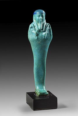 Charming ushabti with blue cap. Charming ushabti with blue cap made of blue faience. Ptolemaic 