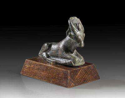 Bronze statuette of the lying Apis bull. Bronze statuette of the lying Apis bull with sun disc 