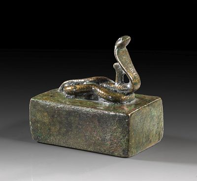 Miniature bronze sarcophagus with an erect cobra. W 4cm, L 8.5cm, H 2.5cm, total H 6.5cm. Late 