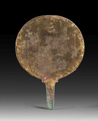 Bronze mirror. Late Period, 1st millennium BC. L 20cm. Green patina on the backside.