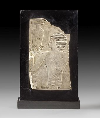 Fragment of a limestone relief. Fragment of a limestone relief showing a young man with short 