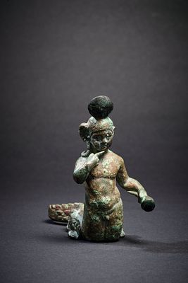 Bronze figure of Harpocrates. A bronze figure of the young Harpocrates holding his right finger 