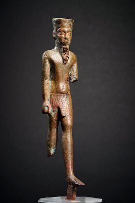 Amun. Bronze figure of striding Amun, H 15cm. Late Period, 711 - 323 BC. Male figure wearing 