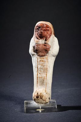 Colorful shabti of a priest. A colourful shabti of a priest with white body and brown glazed 