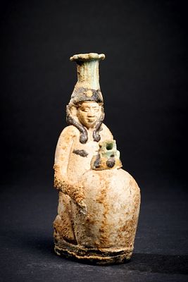 Figurative perfume bottle. Figurative flacon. Faience, H 9.5cm. Kneeling figure (Hapi?) with a 