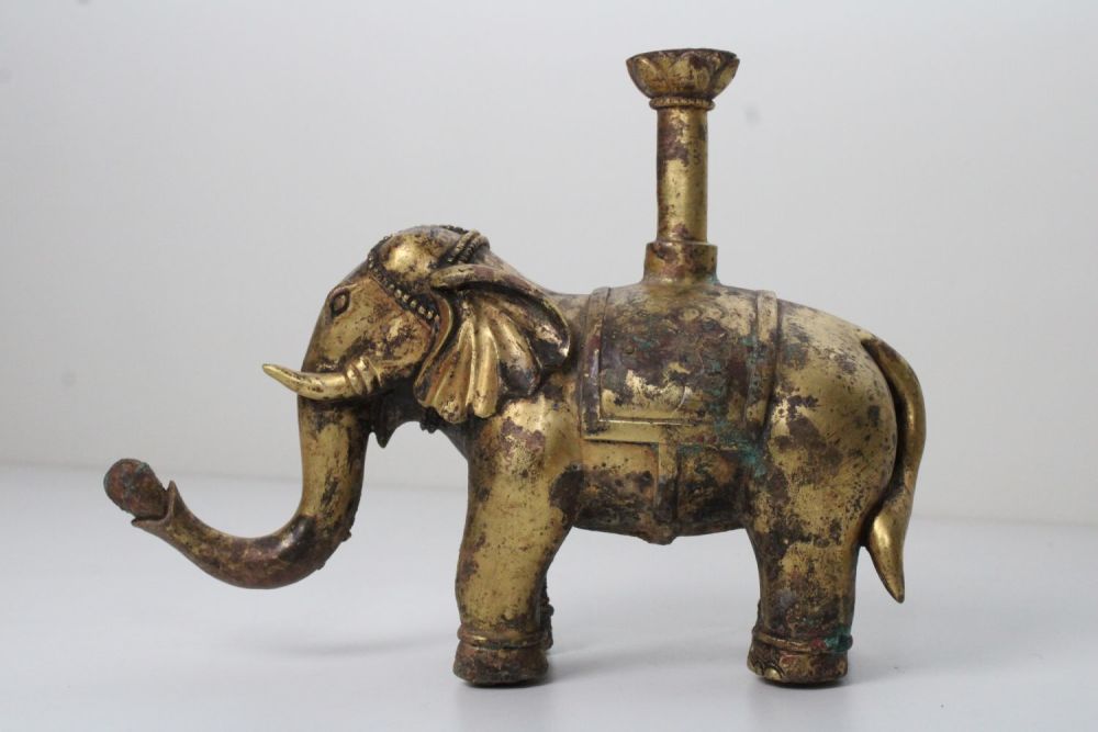 Lot 30: Chinese Bronze Gilt Elephant with Floral Carvings: This...