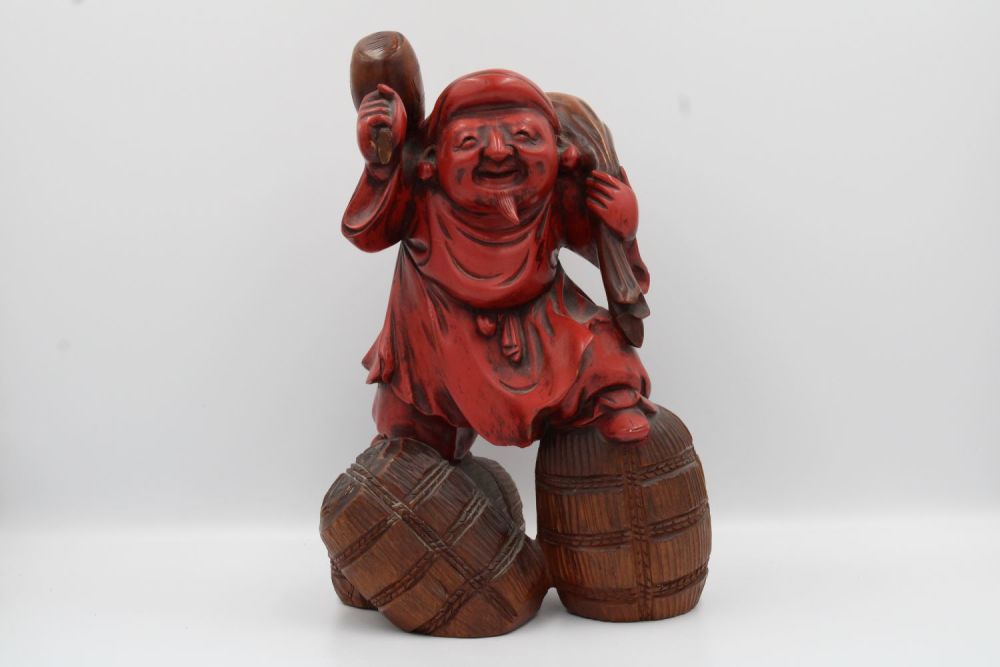 Lot 39: A Japanese figurine, possibly made of wood or...