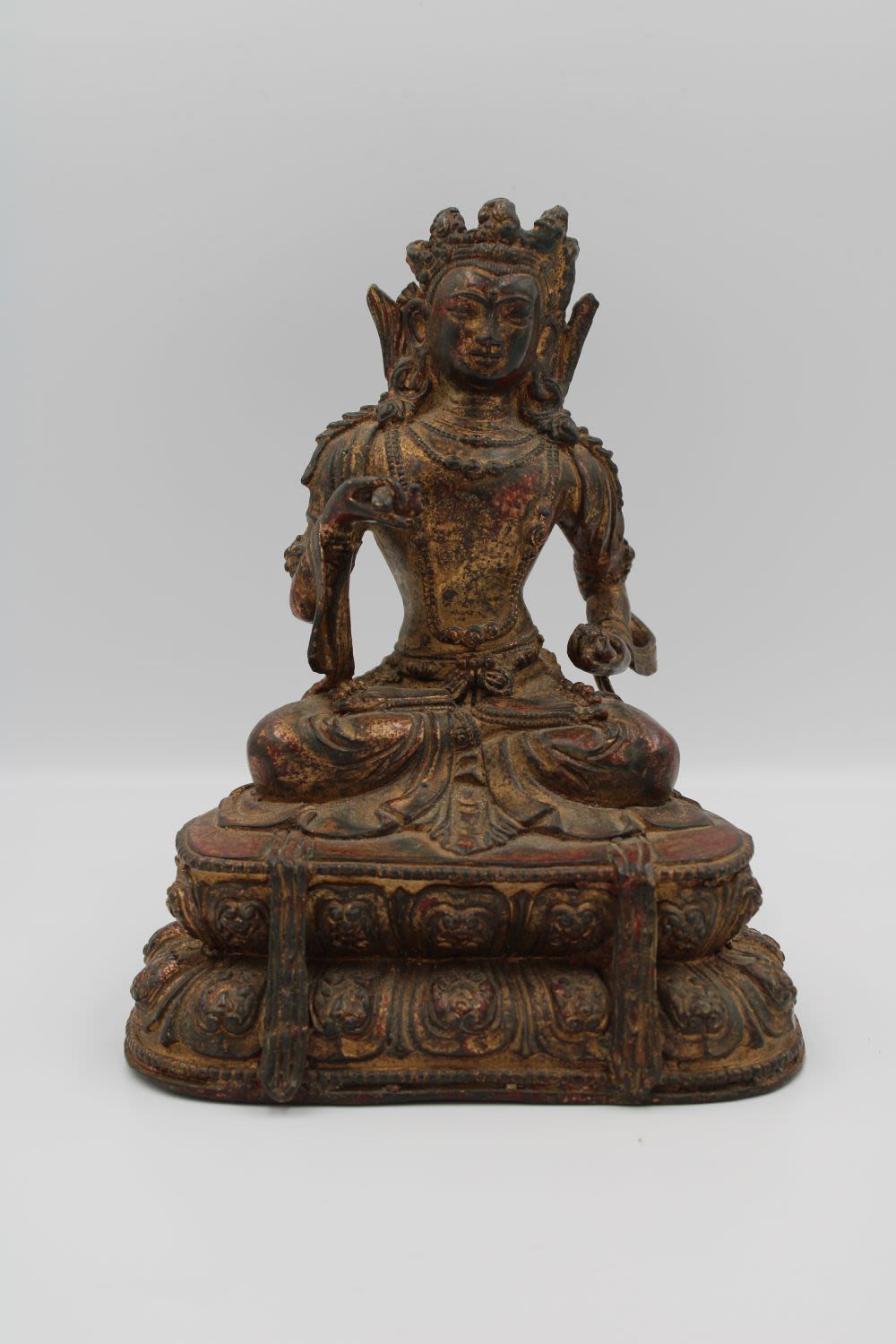 Lot 56: A Chinese Tibetan bronze Buddha figurine in cross...
