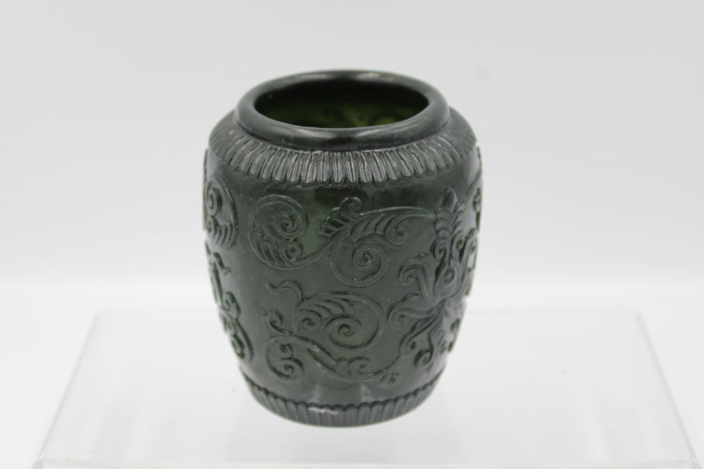 Lot 58: Chinese green jade bowl adorned with floral patterns...