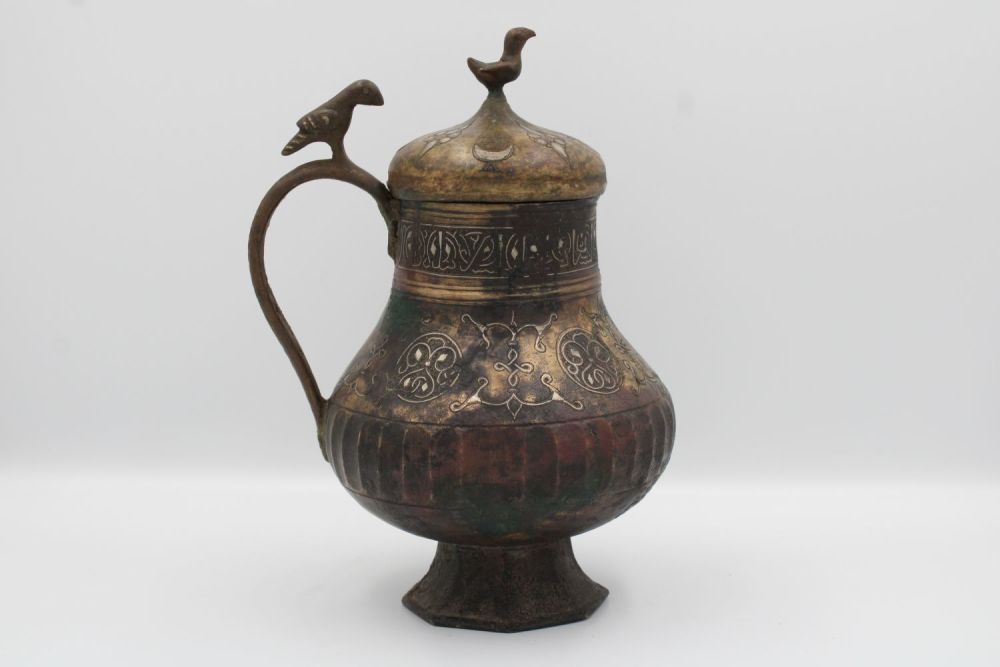 Lot 99: 12th-century Khurasani bronze water jug adorned with Kufic...