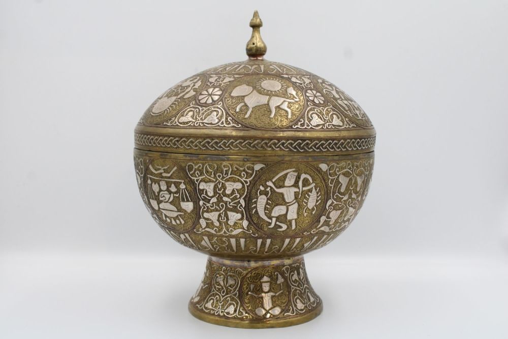 Lot 136: Islamic Bronze Bowl with Kufic Calligraphy: This captivating...