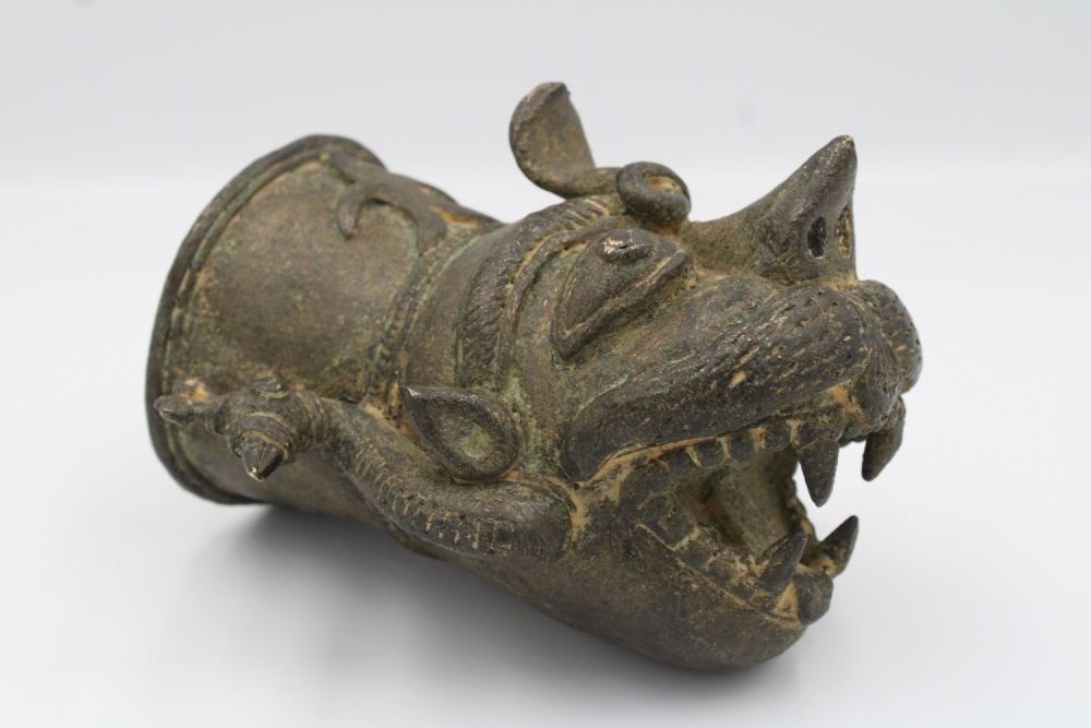Lot 155: Indian mythical bronze head attachment.