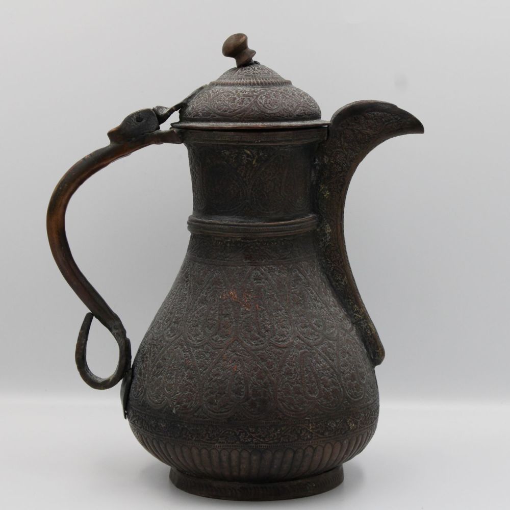 Lot 158: Exquisite Kashmiri Water Jug Adorned with Elaborate Carvings.