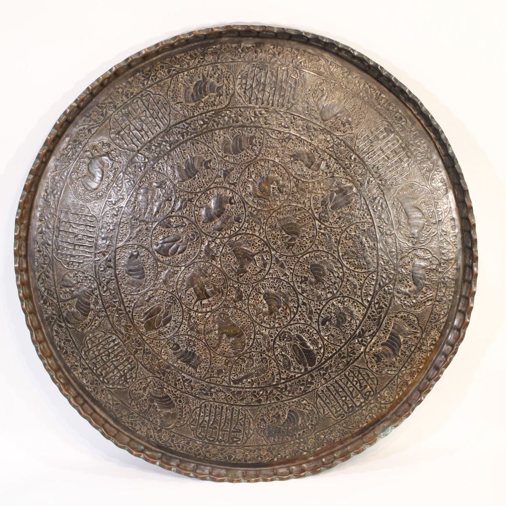 Lot 190: Indo-Persian metal tray featuring intricate animal figure carvings...