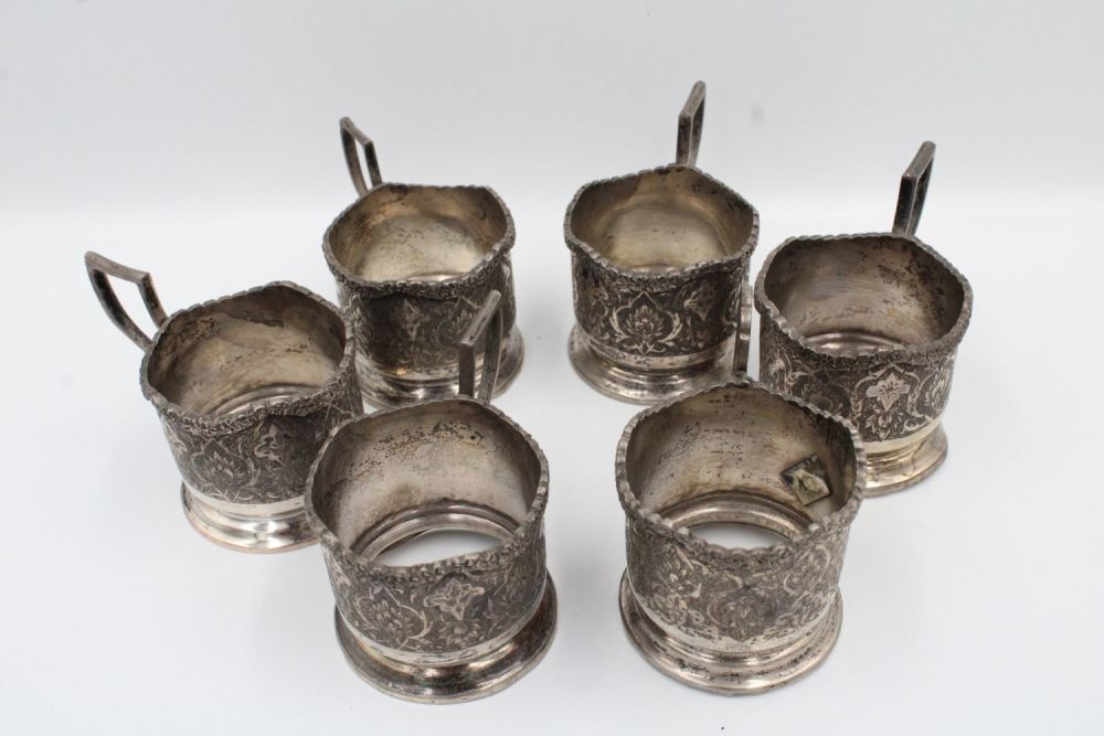 Lot 243: A set of six Persian silver cup holders...