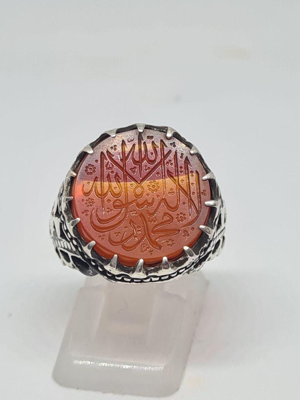 Lot 245: An Islamic silver ring adorned with an engraved...
