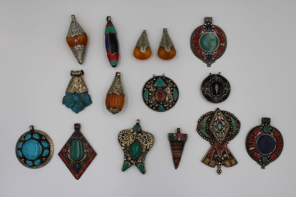 Lot 251: Assorted collection of Tibetan/Nepali pendants crafted from white...