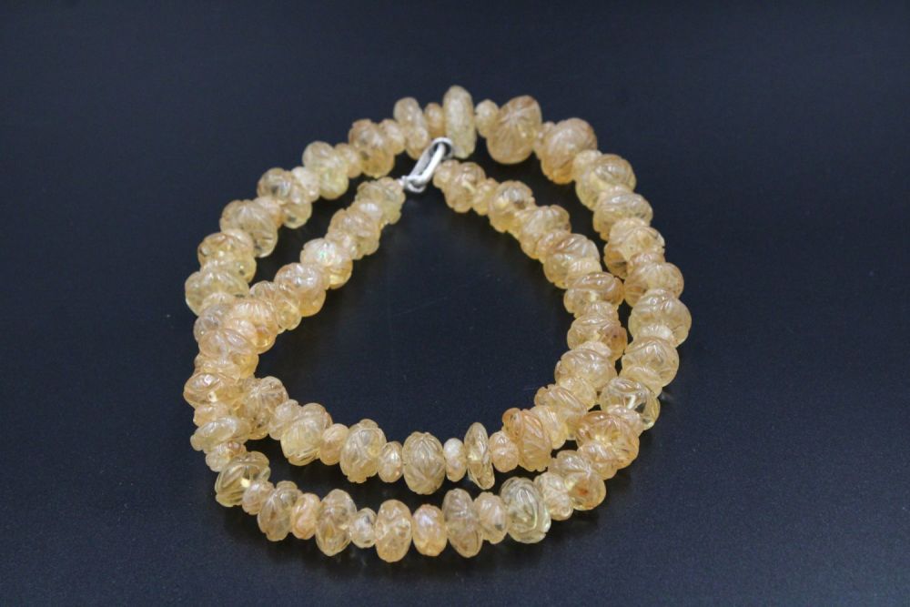 Lot 299: Exquisite crystal necklace adorned with intricate carvings.