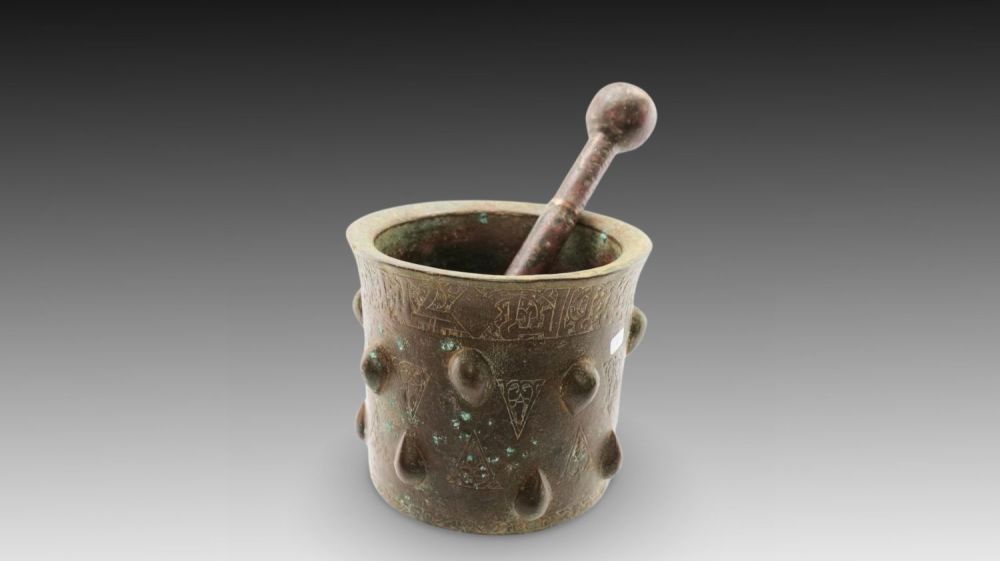 Lot 36: An Islamic Bronze Pestle and Mortar from the...