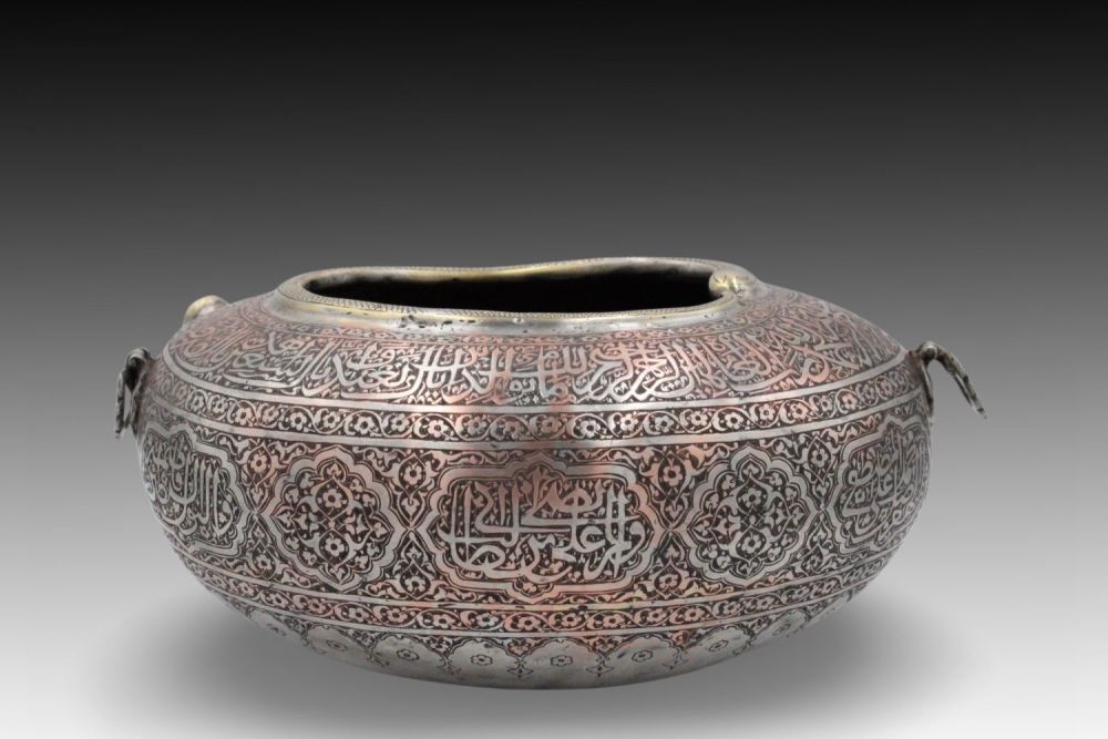 Lot 61: An Islamic Copper Kashkul (Begging Bowl) with Islamic...