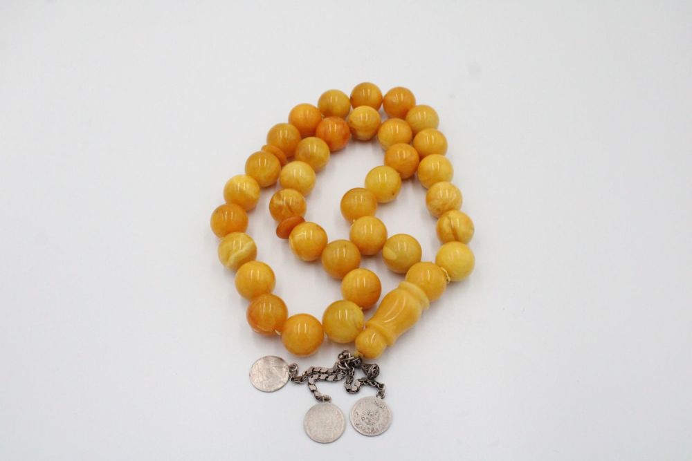 Lot 63: An Islamic Large Butterscotch Amber Prayer Beads with...