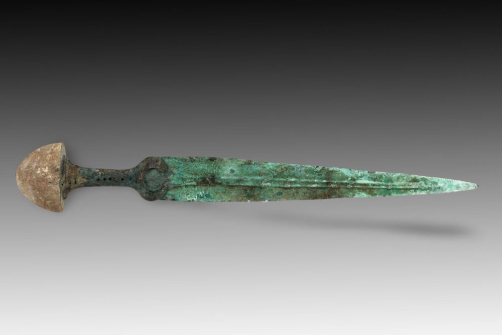 Lot 132: An Ancient Bronze Dagger from Circa 1800-600 BC...