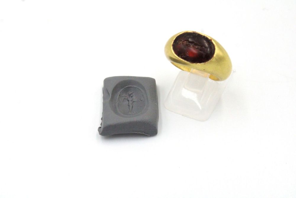 Lot 164: A Hellenistic Gold Ring with Garnet Intaglio of...