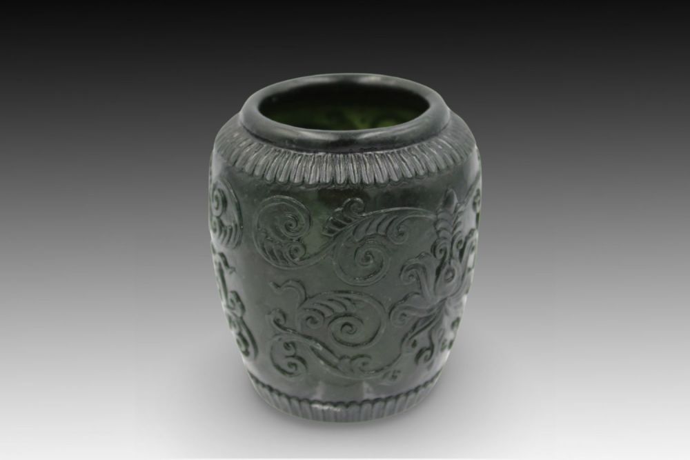 Lot 176: A Chinese Green Jade Bowl adorned with Floral...