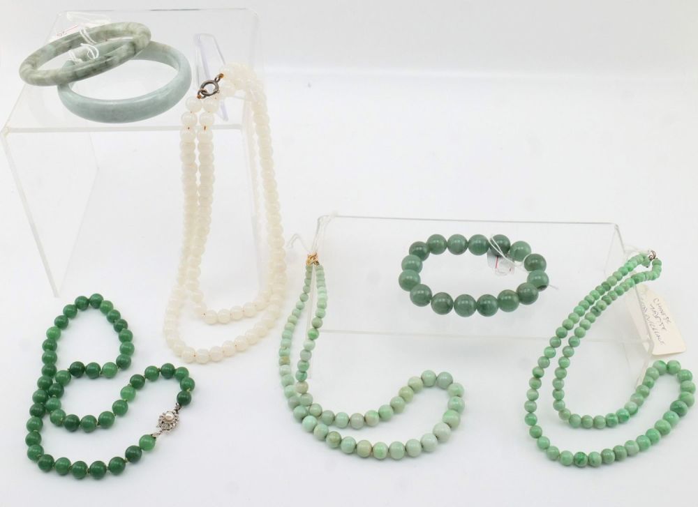 Lot 211: A Chinese Collection of White and Green Jade...