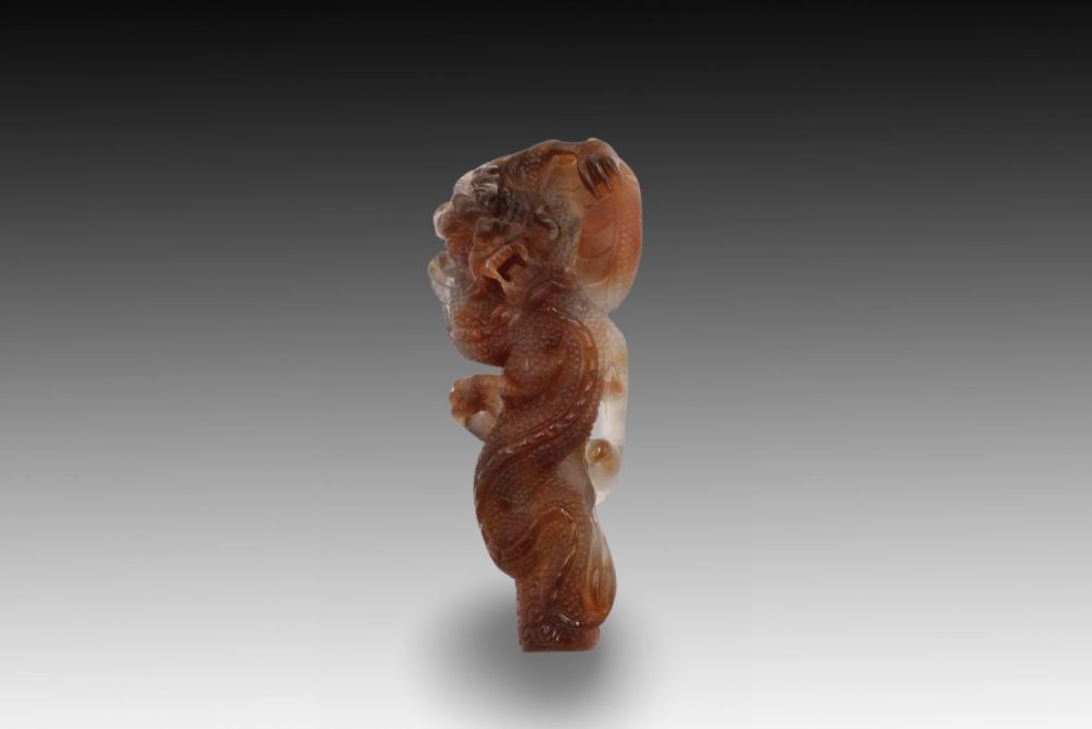 Lot 239: A Chinese Agate Magnificently Carved of a Dragon