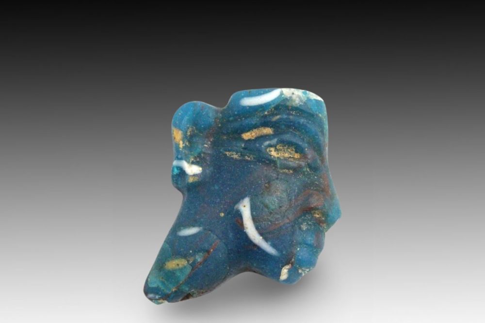 Lot 332: An Ancient Egyptian Ptolemaic Glass Face Inlay from...