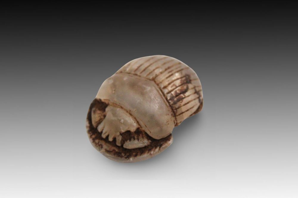 Lot 337: An Egyptian Unpolished Crystal Scarab Pendant.