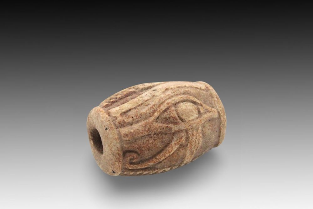Lot 354: An Ancient Egyptian Terracotta Bead with the Eye...
