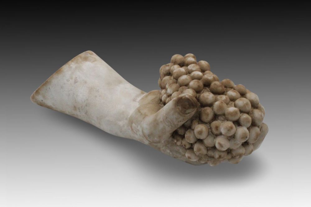 Lot 374: A Roman Marble Arm Holding Grapes, Possible Ancient